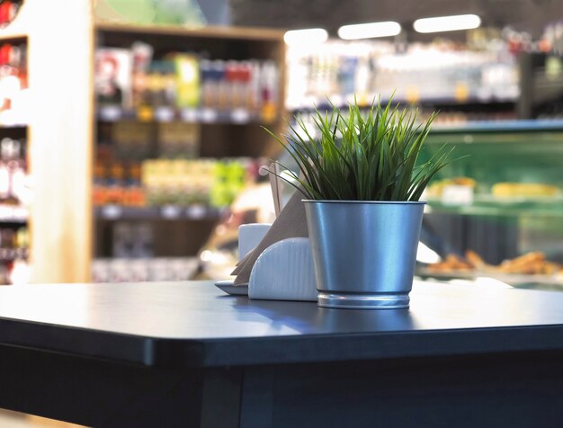 Photo wood table top with blur in coffee shop or cafe restaurant.