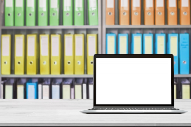 Wood table top with notebook on blurred office document folders standing in a row of on document storage for background