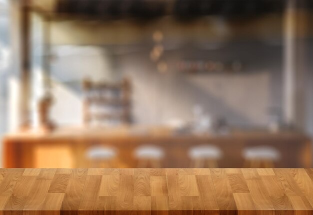 Wood table with blur in coffee shop cafe For montage product display table copy space cafe background with copy space for text