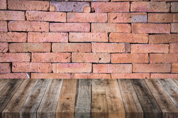 Wood table with red brick wall texture