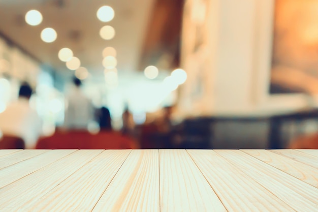 Wood table with Restaurant cafe interior with people abstract defocused blur background