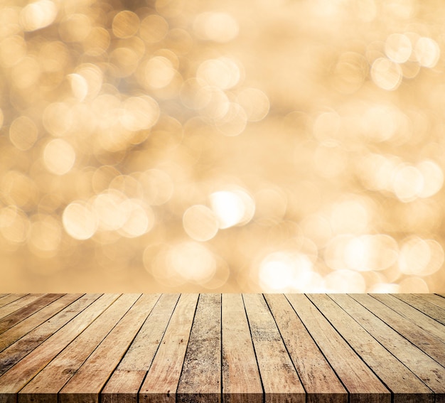 Wood table or wood floor with abstract gold bokeh and fireworks background for product display