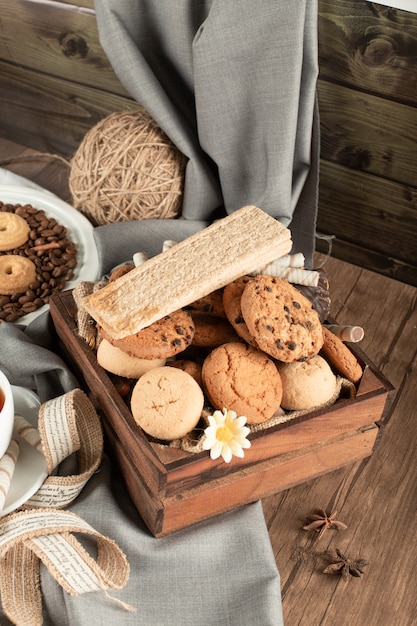 A wood tray of cookies and crackers