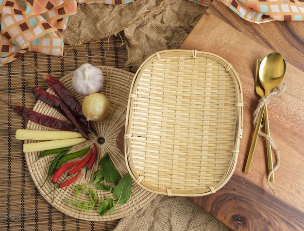 Wood tray with Thai herbs and spoon and fork with free space for text background