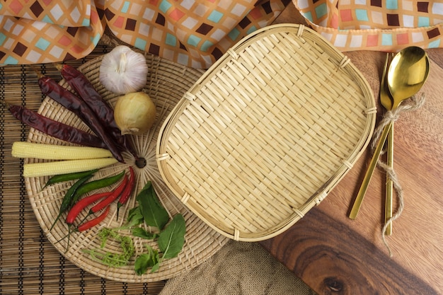 Wood tray with Thai herbs and spoon and fork with free space for text background