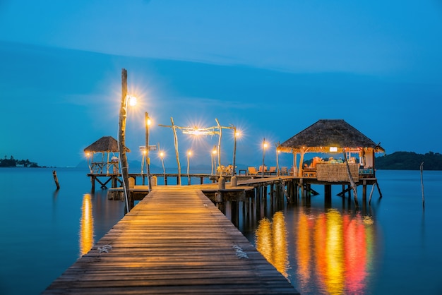 Wooded bridge to Koh Mak harbor after sunset