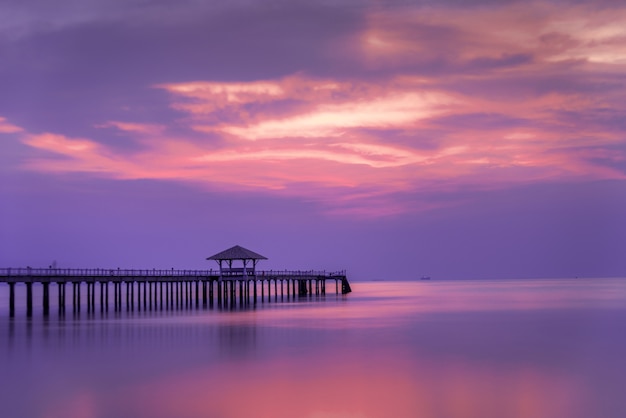 Wooded bridge in the port between sunrise.