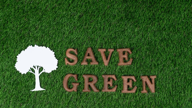 Photo wooden alphabet arranged in ecological awareness campaign with eco icon design on biophilia green grass background to promote environmental protection for greener and sustainable future gyre