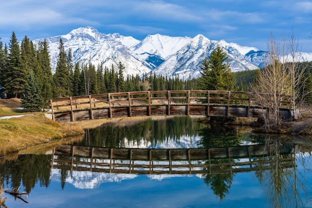 wooden arch footbridge in cascade ponds park in autumn banff national park canadian rockies