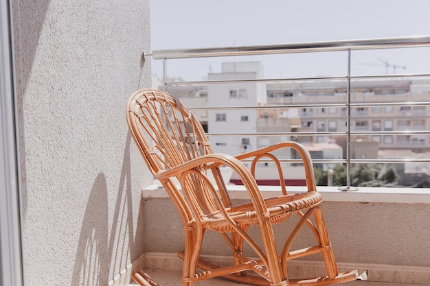 Wooden armchair rocking chair on the terrace closeup