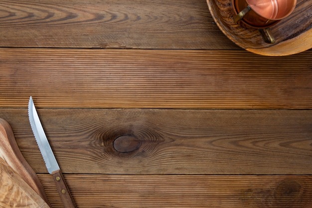 Wooden background. Kitchen utensils, wooden plates and knife.