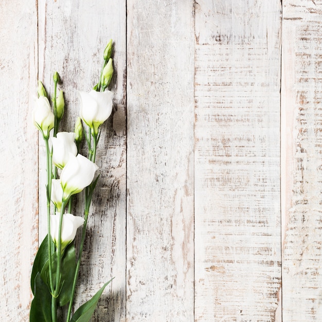 Wooden background with bouquet of white flowers