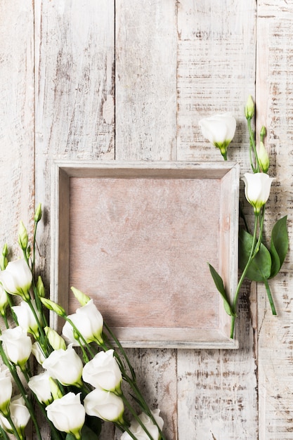 Wooden background with bouquet of white flowers