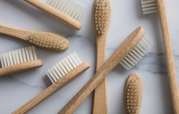 Wooden bamboo toothbrushs on a marble background