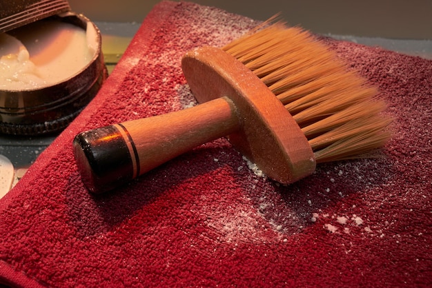 Wooden barber brush detail on a barbershop stand.