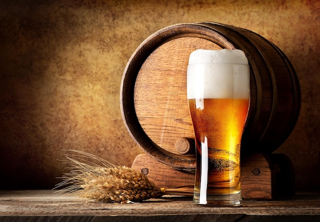 Wooden barrel and beer with wheat on a wooden table