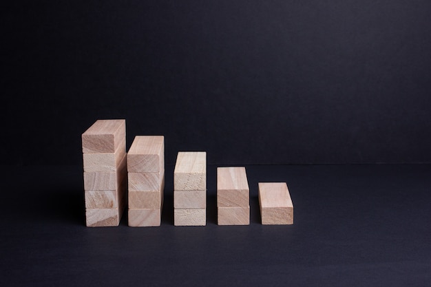 Wooden bars on a dark background. The rise and fall of finance. Banking services.