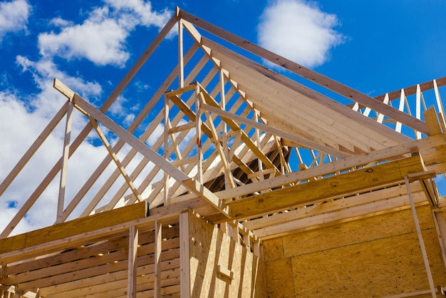 Wooden beams at construction the roof framing truss system house