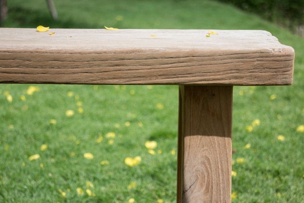 Wooden bench in outdoors garden in summer