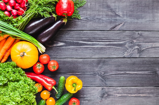 wooden black planks with fresh vegetables.