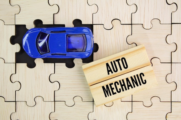 A wooden block with the words auto mechanic on it