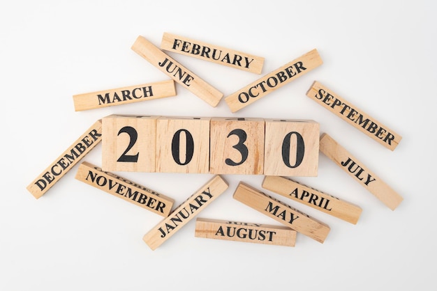 Photo wooden blocks and cubes with the year 2030 and the 12 months of the year