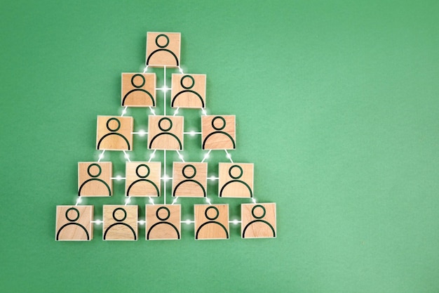 Wooden blocks with faces on them on a green table.