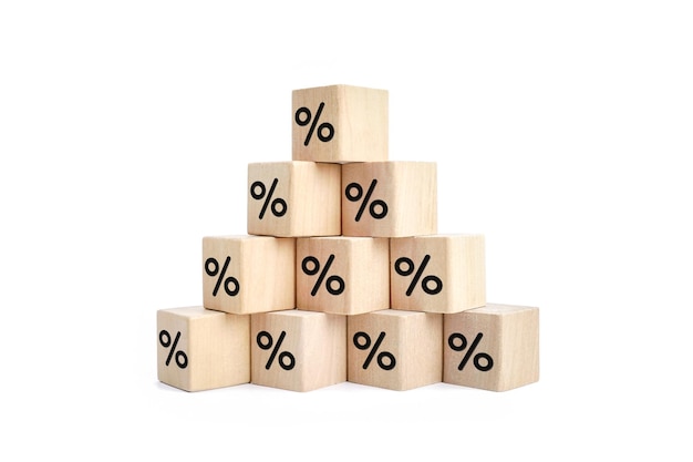 Wooden blocks with percentage sign interest rate decline investment reduce or Sales discount