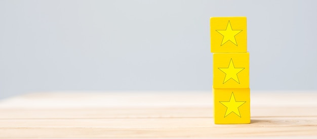 Wooden blocks with the star symbol. Customer reviews, feedback, rating, ranking and service concept.