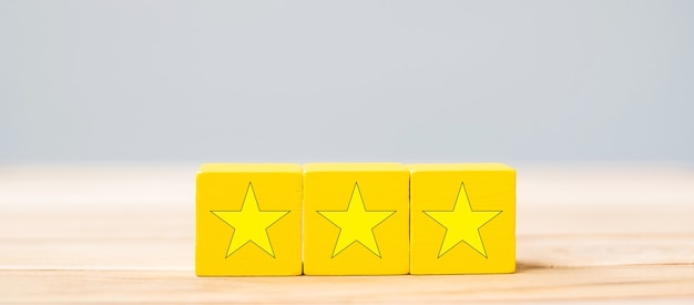 Wooden blocks with the star symbol. Customer reviews, feedback, rating, ranking and service concept.