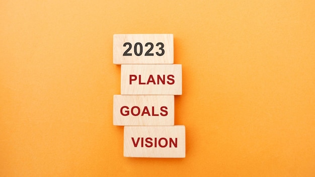 Wooden blocks with the word 2023 plans goals vision Setting goal target for next year Plans and tasks Financial management in company Business and finance concept