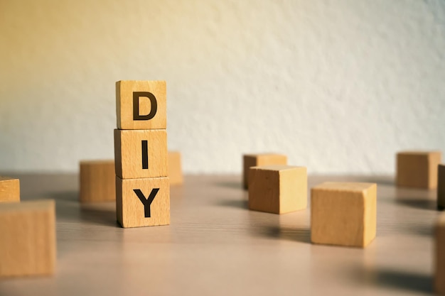 Wooden blocks with the word DIY Do It Yourself concept The method of selfcreation of things without the help of professionals Selective focus