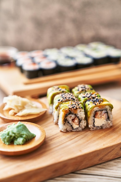 Wooden board of shrimp and cheese cream uramaki sushi on a wooden surface