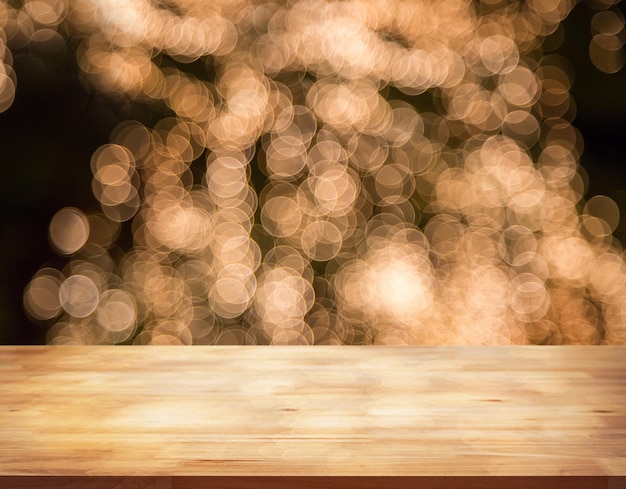 Wooden board table and blurred bokeh light at night background Perspective modern brown wood bar