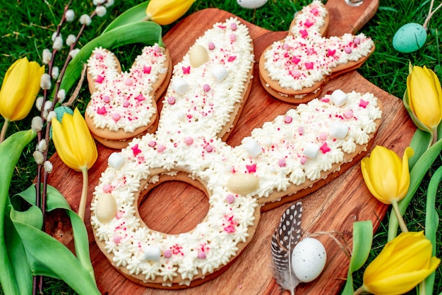 A wooden board with easter bunny shaped cookies on it