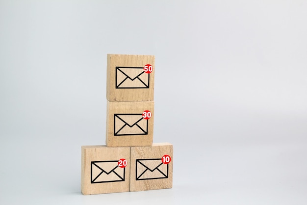 wooden board with email icon. the concept of getting an email. Junk email, spam mail and email over