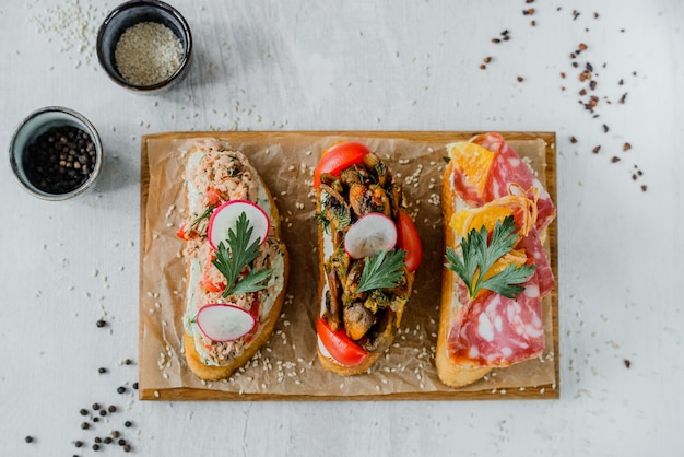 Wooden board with tasty fresh bruschettas on table