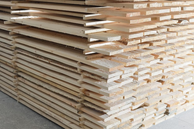 Wooden boards are stacked in a sawmill or carpentry shop Drying and marketing of wood