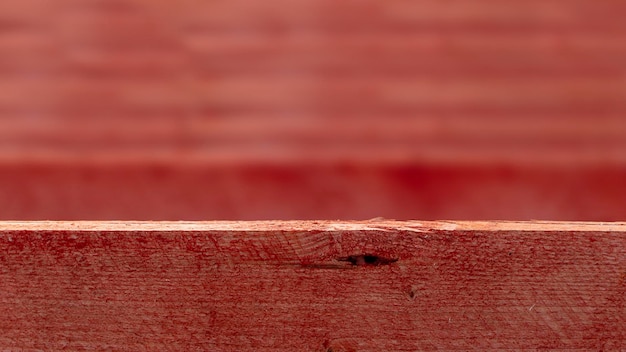 Wooden boards covered with red paint at construction site