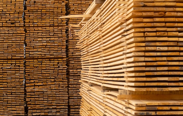 Wooden boards lumber industrial wood timber Pine wood timber stack of natural rough wooden boards on building site Industrial timber building materials