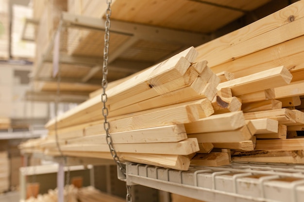 Wooden boards slats lumber in the foreground Stacked lumber Folded wood Boards in the warehouse