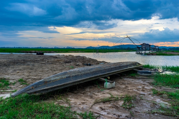 Wooden boat and fishing net  trap in the river