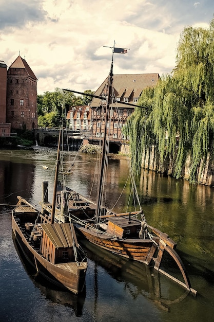 Wooden boats on river with houses