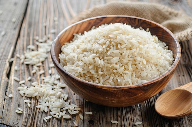 A wooden bowl filled with white rice sits next to a wooden spoon on a table Generative AI