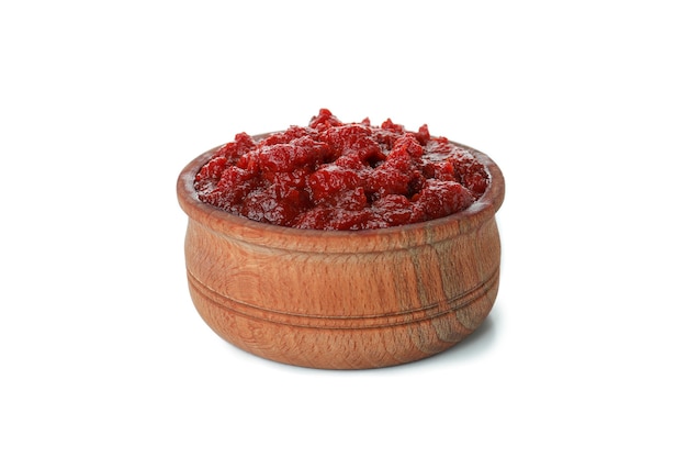 Wooden bowl of tomato paste isolated on white background