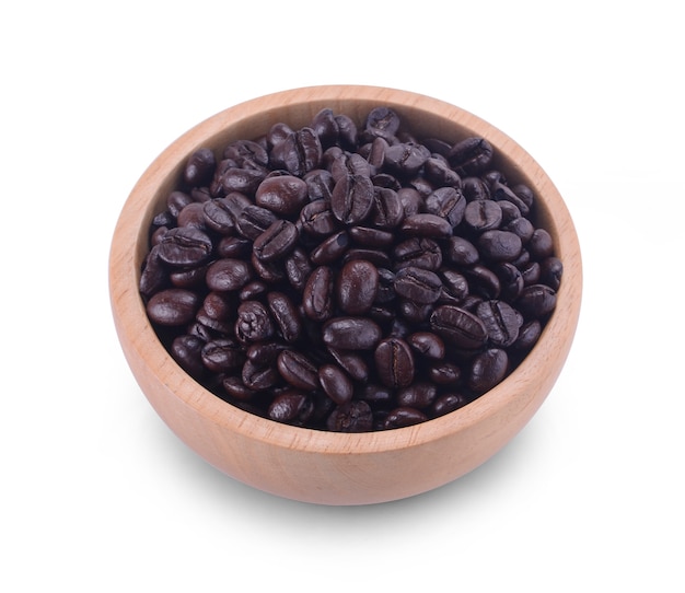 Wooden Bowl with coffee beans and coffee leaf on white background.