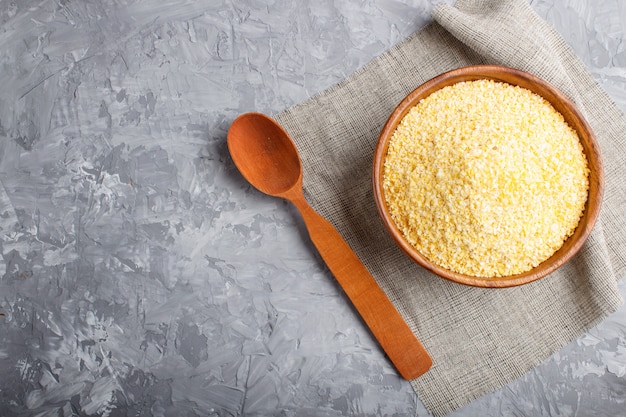 Wooden bowl with cornflakes and a wooden spoon 