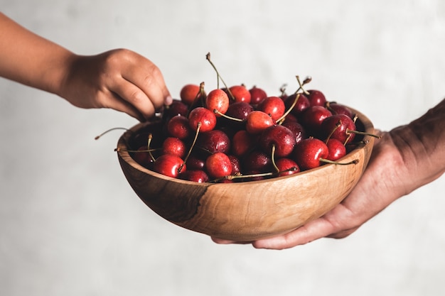 Wooden bowl with fresh juicy berries.