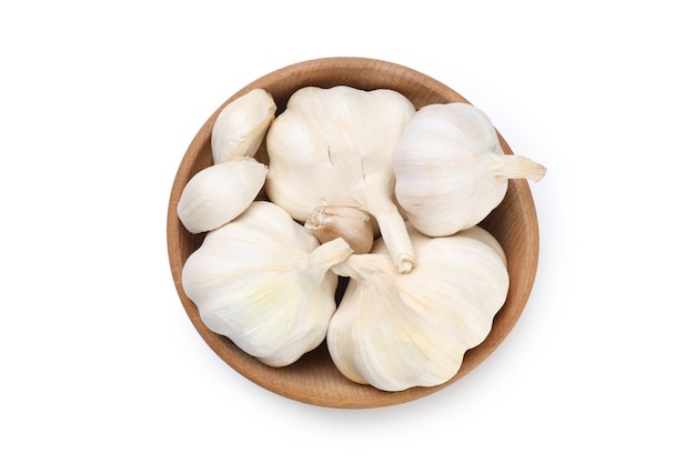 Wooden bowl with garlic isolated on white background