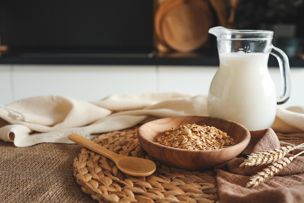 Wooden bowl with granola and jug of milk breakfast concept